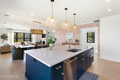 a large kitchen with kitchen island a sink counter space and living room view