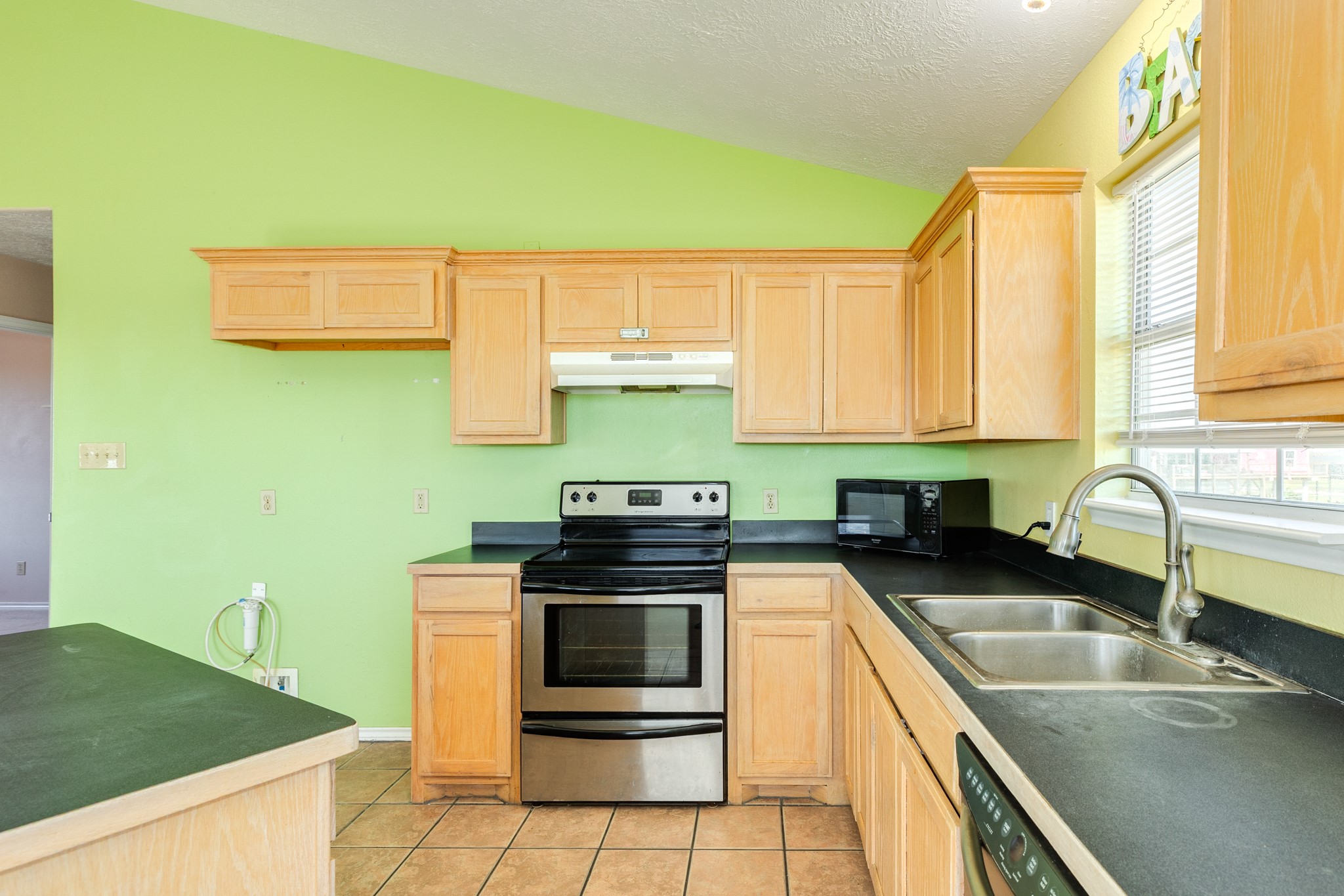 118 Lindrose Freeport, TX 77541 - Photo 16 of 26 a kitchen with a sink a stove and cabinets