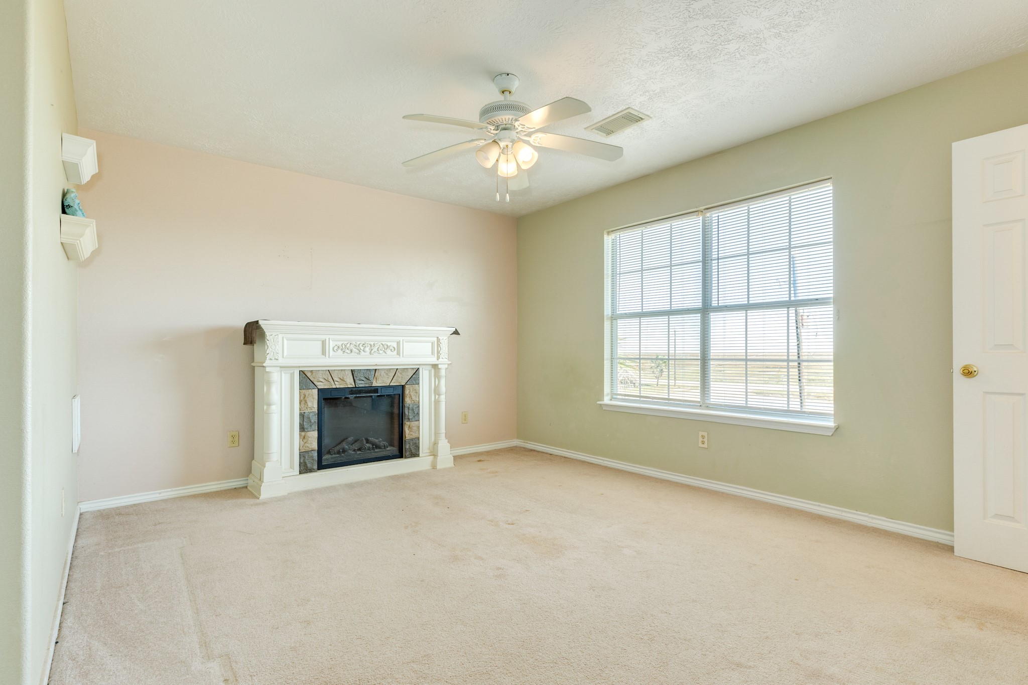 118 Lindrose Freeport, TX 77541 - Photo 17 of 26 an empty room with chandelier fan and windows