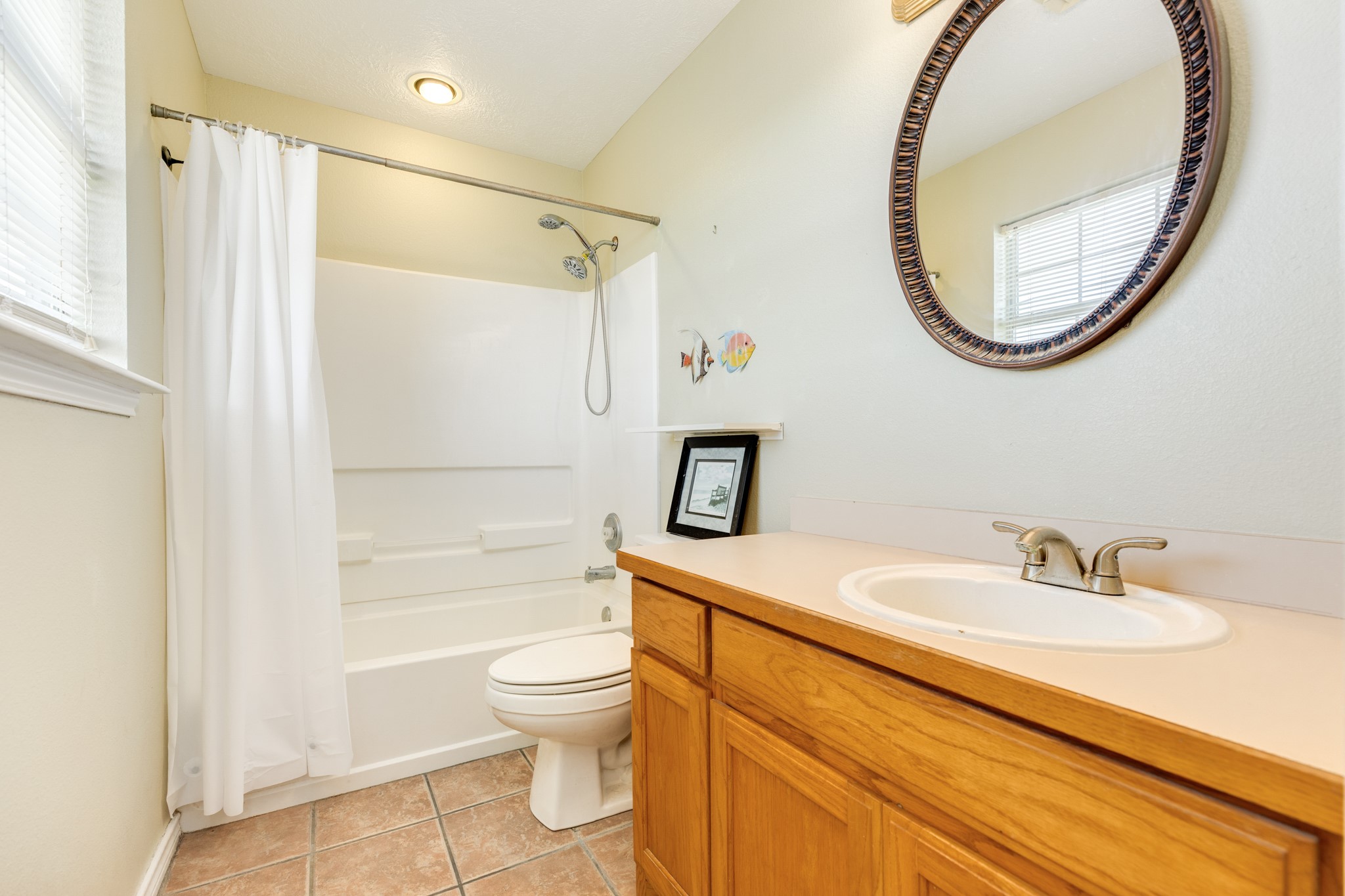 118 Lindrose Freeport, TX 77541 - Photo 19 of 26 a bathroom with a sink a mirror a toilet and a shower