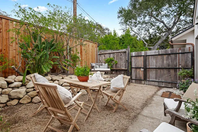 a view of a patio with couple of chairs