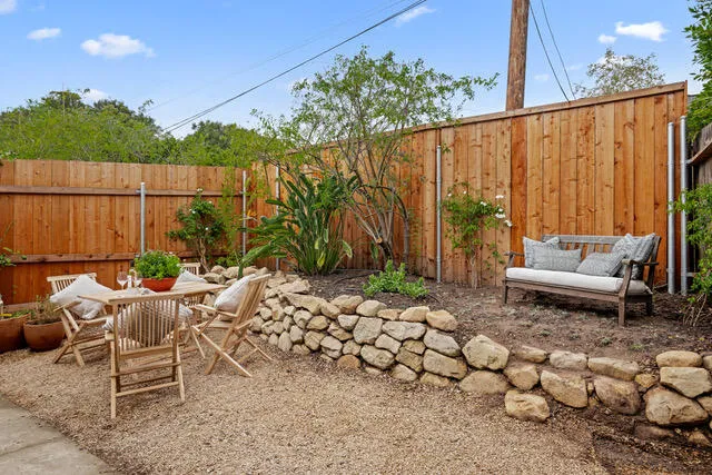 a view of a chairs and tables in the back yard of the house