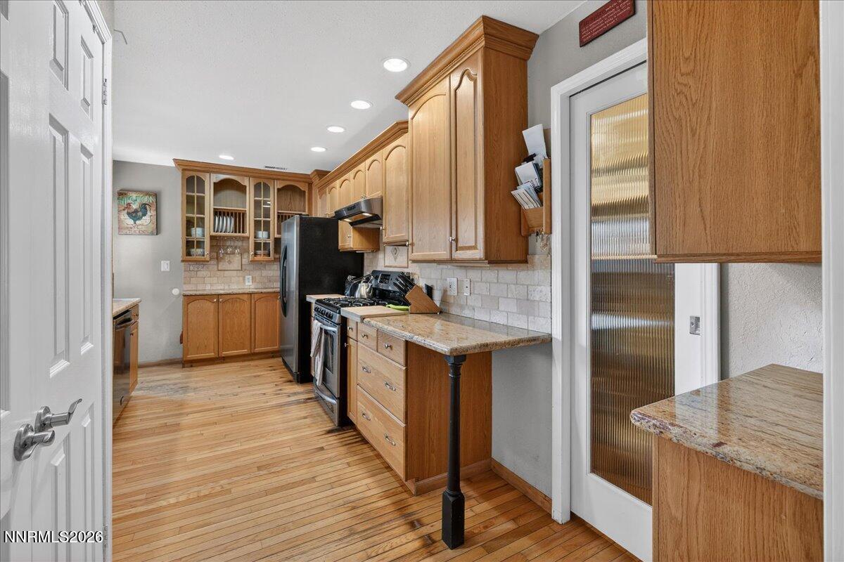 1831 North Division Street Carson City, NV 89703 - Photo 12 of 35 a kitchen with stainless steel appliances granite countertop a refrigerator a sink and a stove
