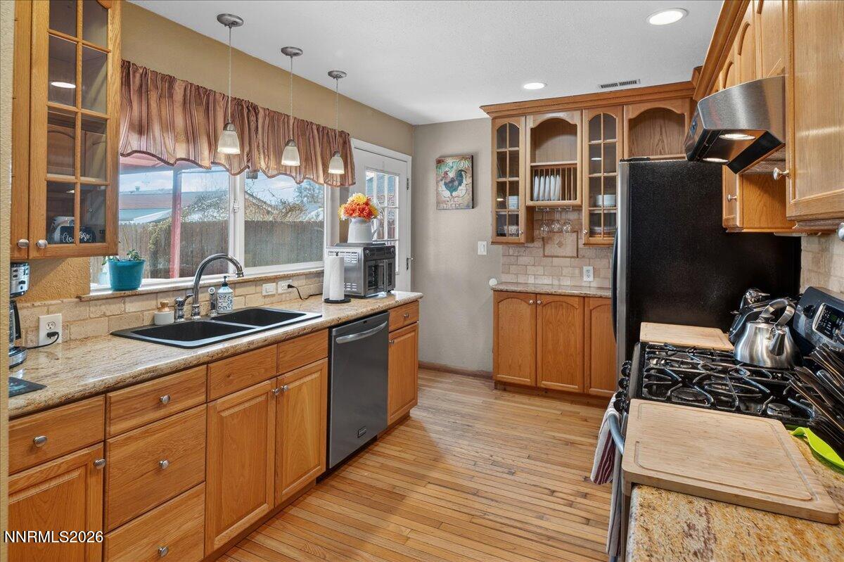 1831 North Division Street Carson City, NV 89703 - Photo 14 of 35 a kitchen with stainless steel appliances granite countertop a sink and wooden cabinets