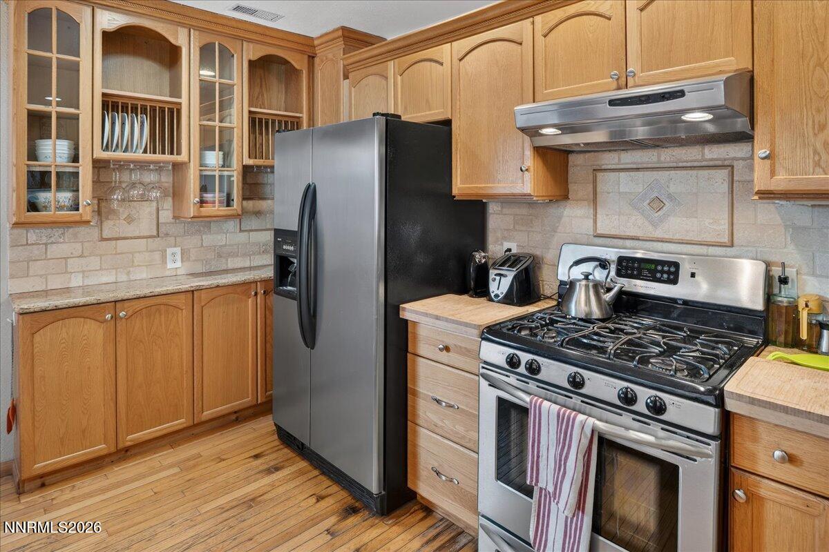 1831 North Division Street Carson City, NV 89703 - Photo 15 of 35 a kitchen with stainless steel appliances granite countertop a stove and a refrigerator
