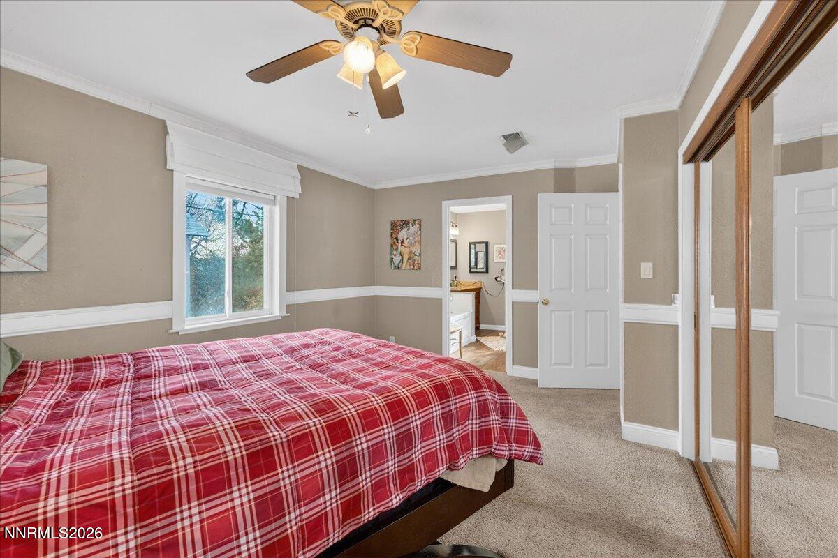1831 North Division Street Carson City, NV 89703 - Photo 19 of 35 a bedroom with a bed and a chandelier