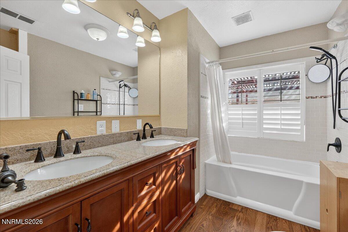 1831 North Division Street Carson City, NV 89703 - Photo 26 of 35 a bathroom with a sink double vanity granite tub and shower