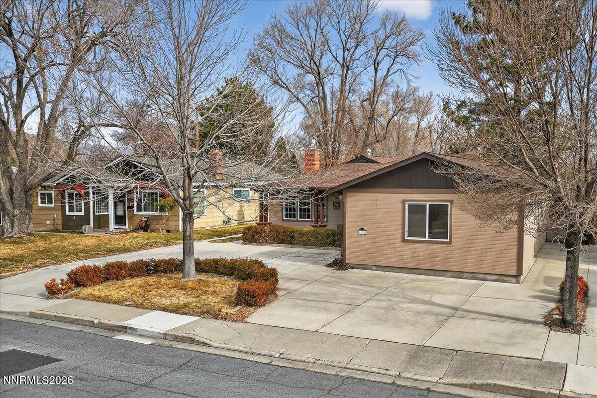 1831 North Division Street Carson City, NV 89703 - Photo 3 of 35 a front view of a house with a yard covered with trees