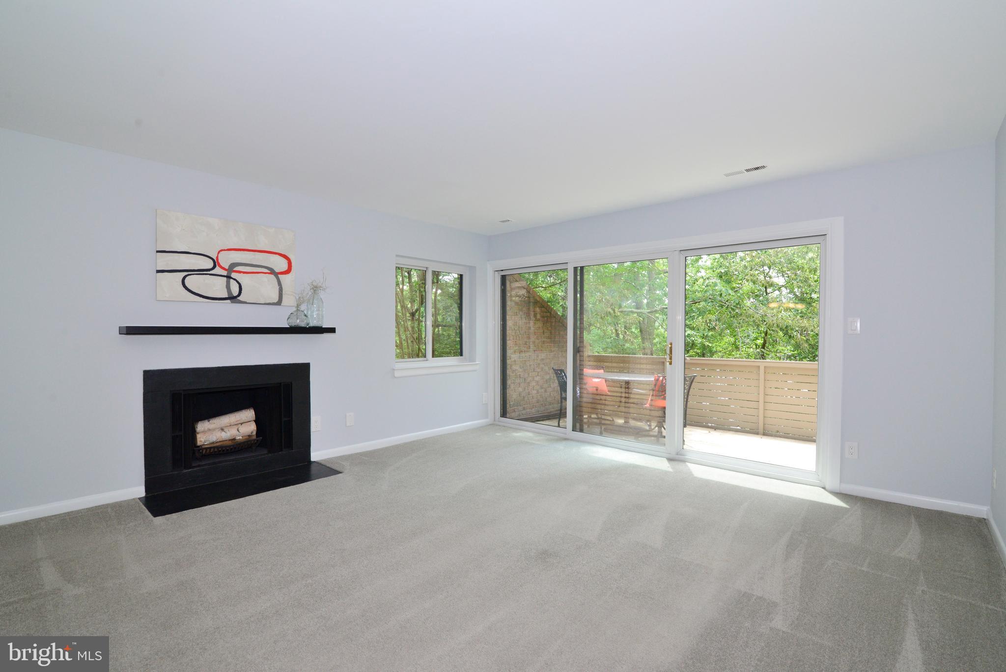 11128 Harbor Court Reston, VA 20191 - Photo 5 of 44 The living room features a wood-burning fireplace.