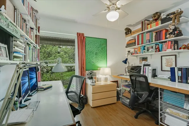 a view of a workspace with furniture and a bookshelf