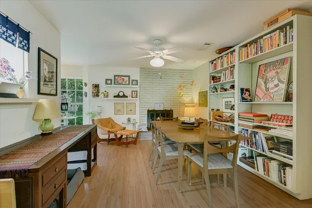 a view of a dining room with furniture wooden floor and a chandelier
