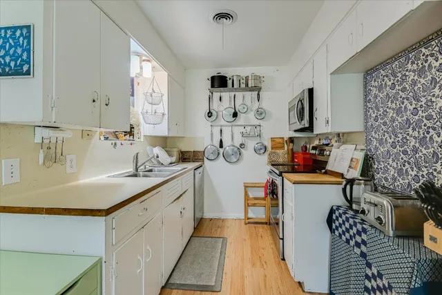 a view of kitchen with sink and wooden floor