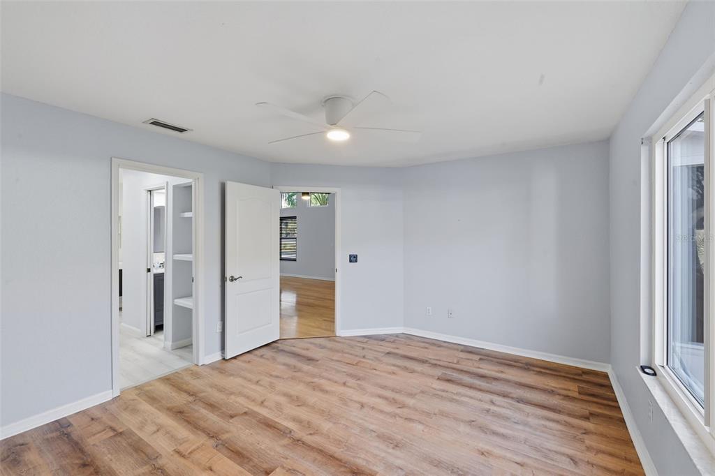 21425 Clubside Loop Lutz, FL 33549 - Photo 13 of 42 a big room with wooden floor and bathroom view