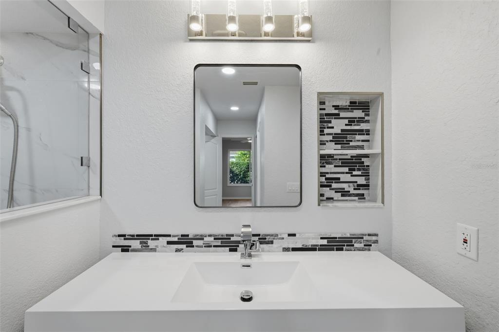 21425 Clubside Loop Lutz, FL 33549 - Photo 16 of 42 a bathroom with a bathtub a sink and a mirror
