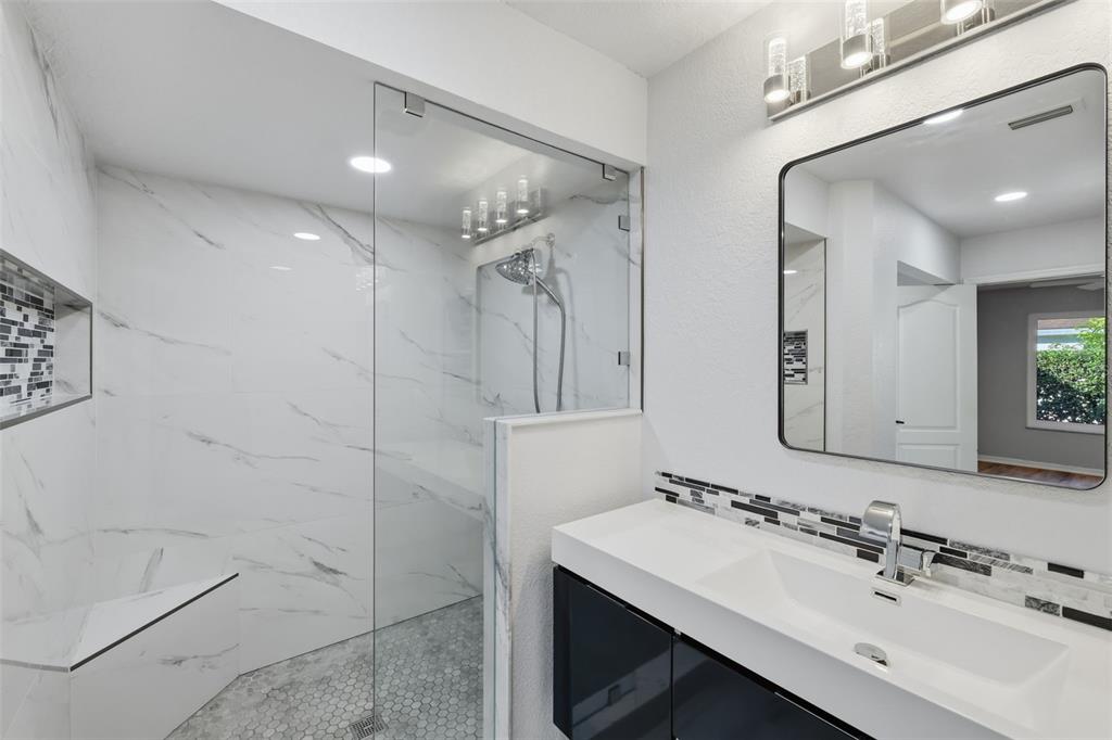 21425 Clubside Loop Lutz, FL 33549 - Photo 17 of 42 a bathroom with a sink mirror and shower