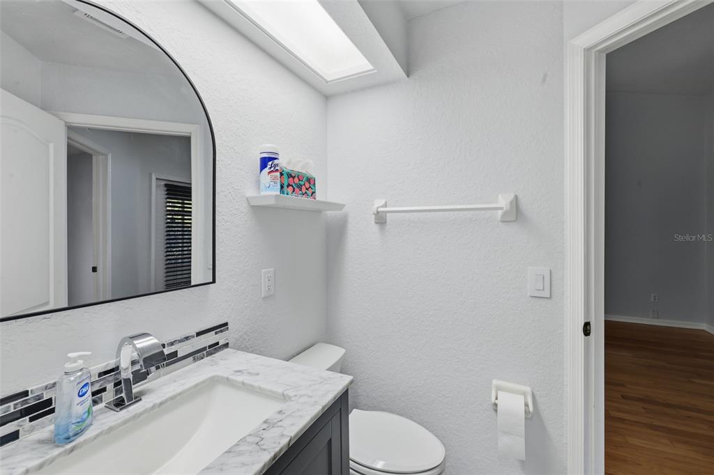 21425 Clubside Loop Lutz, FL 33549 - Photo 18 of 42 a bathroom with a granite countertop sink mirror and toilet