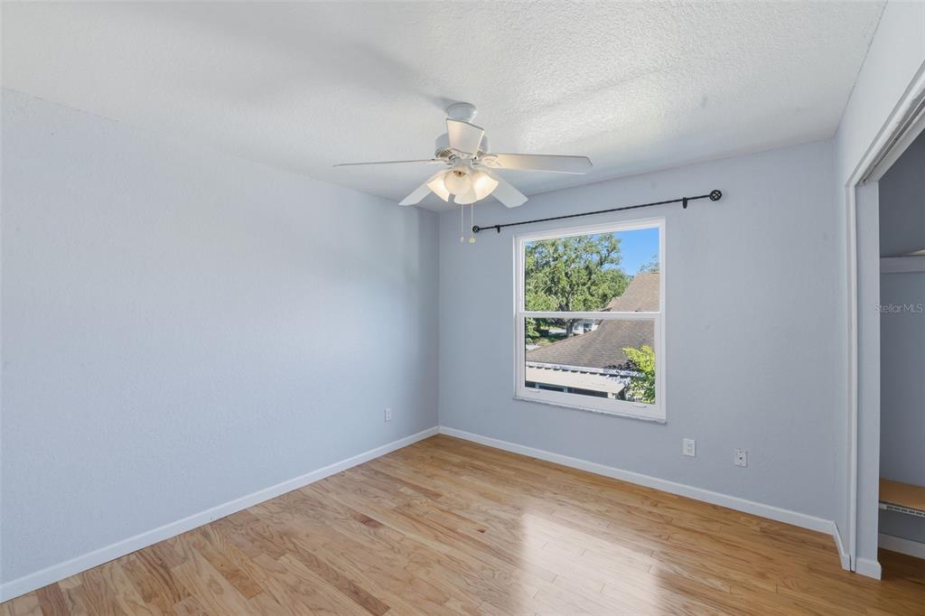 21425 Clubside Loop Lutz, FL 33549 - Photo 21 of 42 wooden floor in an empty room with a window