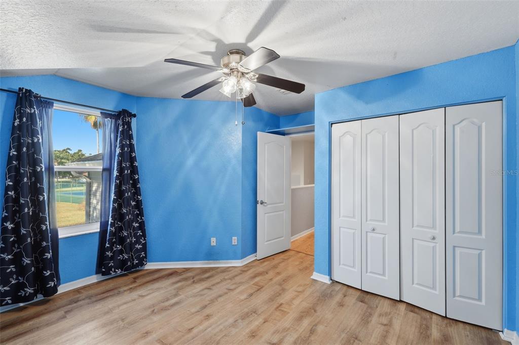 21425 Clubside Loop Lutz, FL 33549 - Photo 25 of 42 a view of an empty room with window and chandelier fan