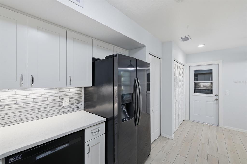 21425 Clubside Loop Lutz, FL 33549 - Photo 8 of 42 a kitchen with metallic refrigerator and countertop