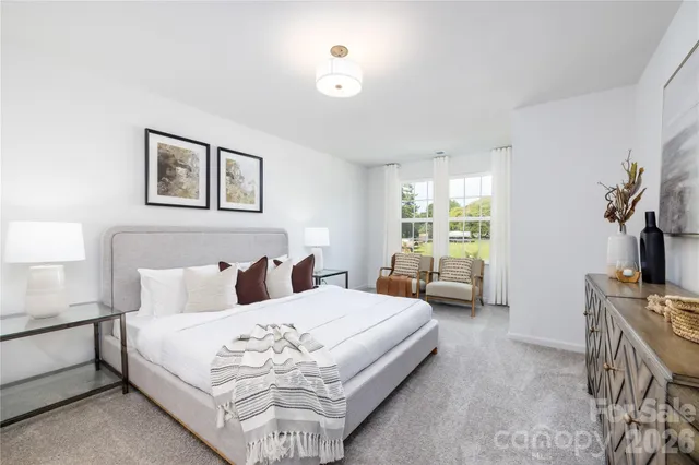 a bedroom with a bed couch and window