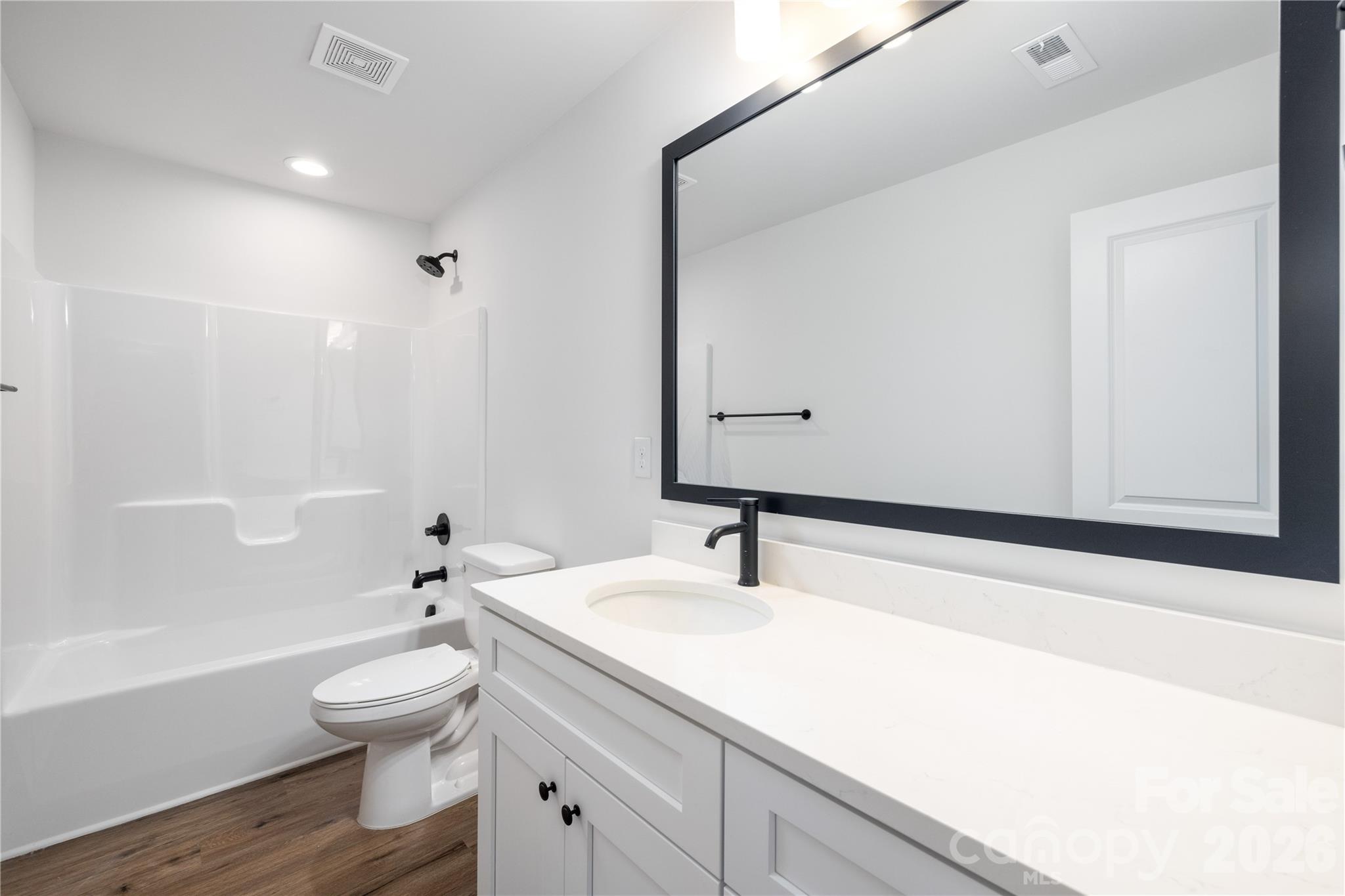 1422 Summerville Road Charlotte, NC 28214 - Photo 18 of 24 a bathroom with a sink a toilet and a large mirror