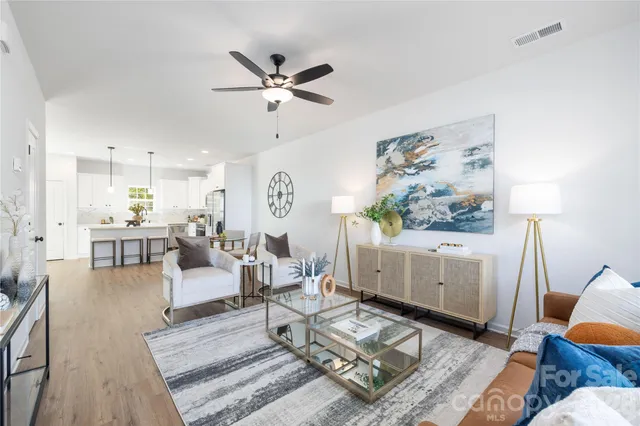 a living room with furniture and wooden floor