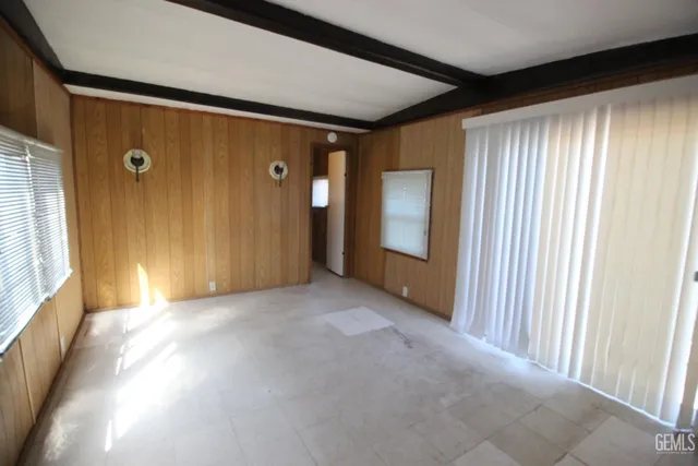 a view of a livingroom with an empty space and a window
