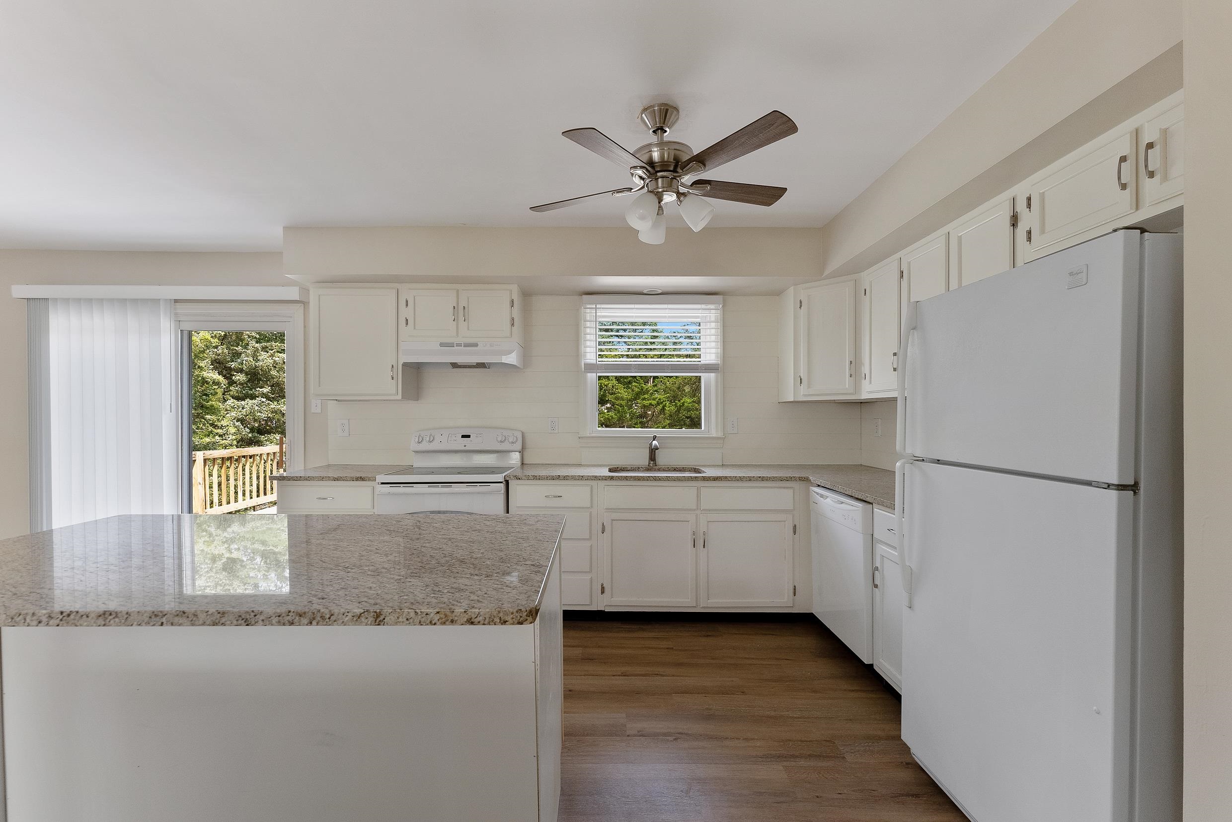 119 Butter Ocean View, NJ 08230 - Photo 2 of 29 a kitchen with a refrigerator a sink and dishwasher with wooden floor