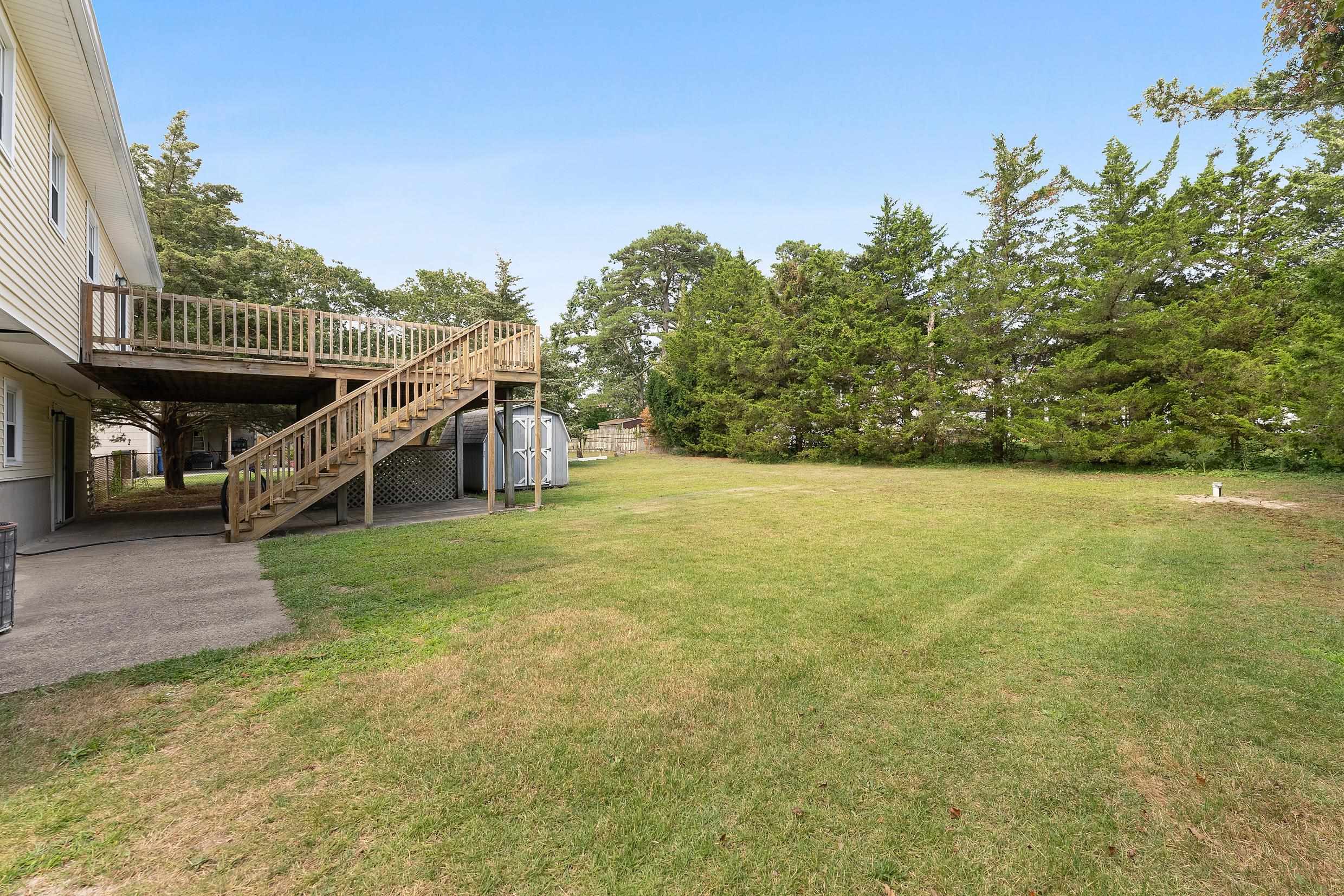 119 Butter Ocean View, NJ 08230 - Photo 28 of 29 a view of a house with a yard
