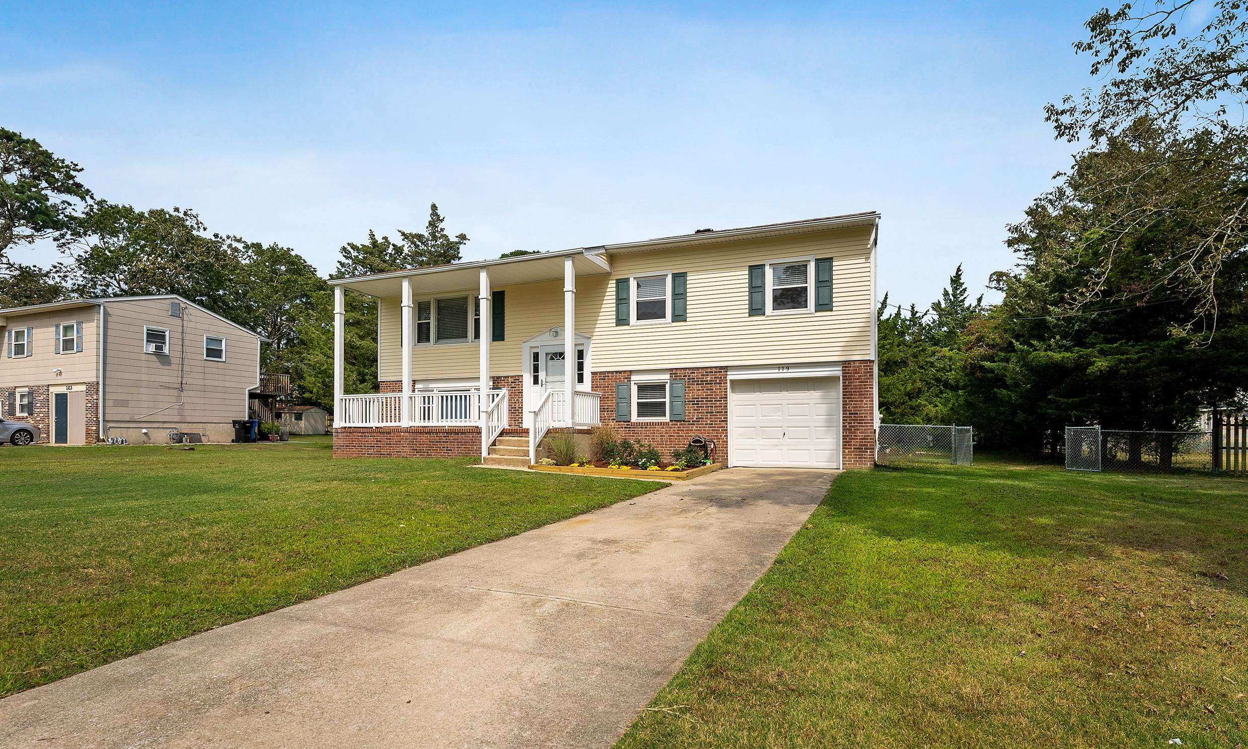 119 Butter Ocean View, NJ 08230 - Photo 29 of 29 a front view of a house with a yard and garage
