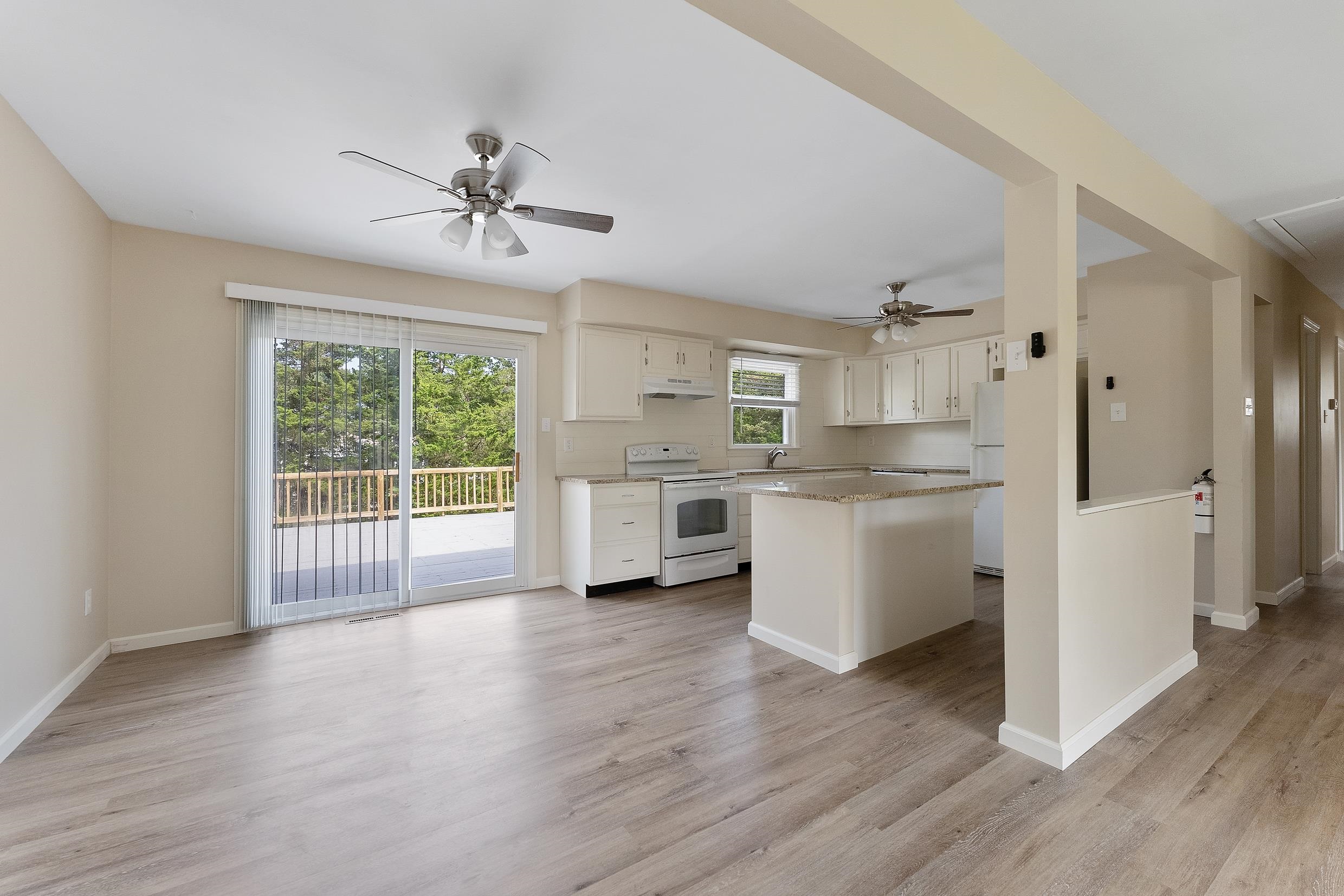 119 Butter Ocean View, NJ 08230 - Photo 8 of 29 a kitchen with stainless steel appliances a white cabinets and wooden floor