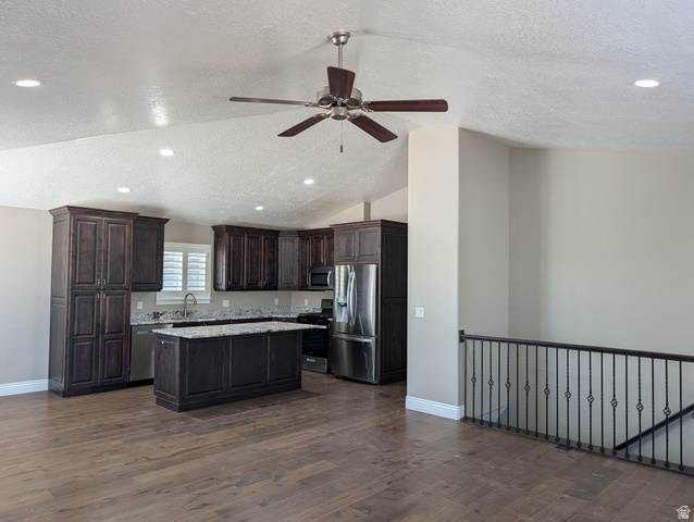 171 South Mustang Road East Grantsville, UT 84029 - Photo 6 of 41 Kitchen featuring dark wood cabinetry, stainless steel appliances, and granite countertops