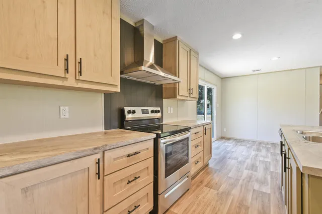 a kitchen with stainless steel appliances granite countertop a stove and a sink