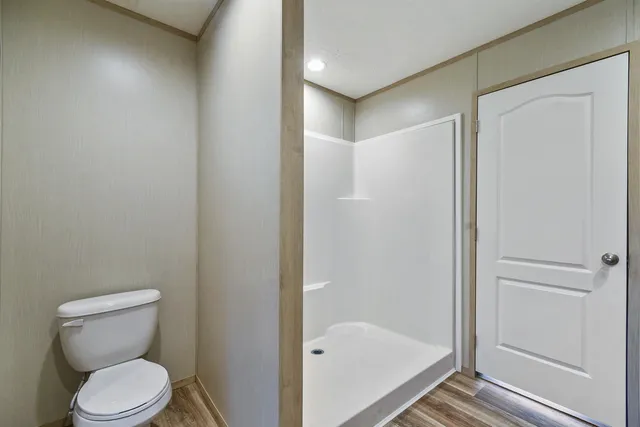 a bathroom with a toilet and shower