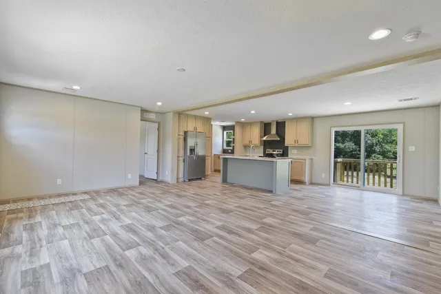 a view of a kitchen with wooden floor and windows