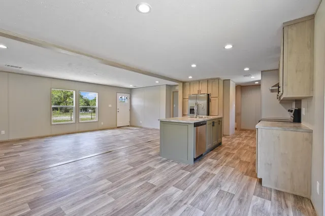 a view of kitchen with wooden floor and electronic appliances