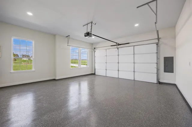 an empty room with windows and ceiling fan