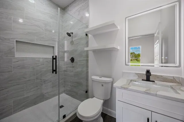 a bathroom with a sink toilet and shower