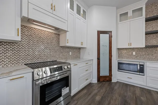 a kitchen with a stove and a microwave