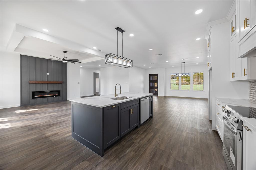 4651 Grand View Drive Athens, TX 75752 - Photo 10 of 23 a large kitchen with stainless steel appliances kitchen island a large counter top and a wooden floors