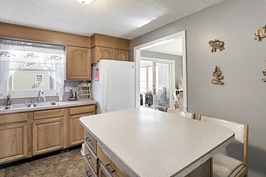 485 Riverside Road Springfield, MA 01107 - Photo 16 of 33 a kitchen with a white cabinets sink and stainless steel appliances