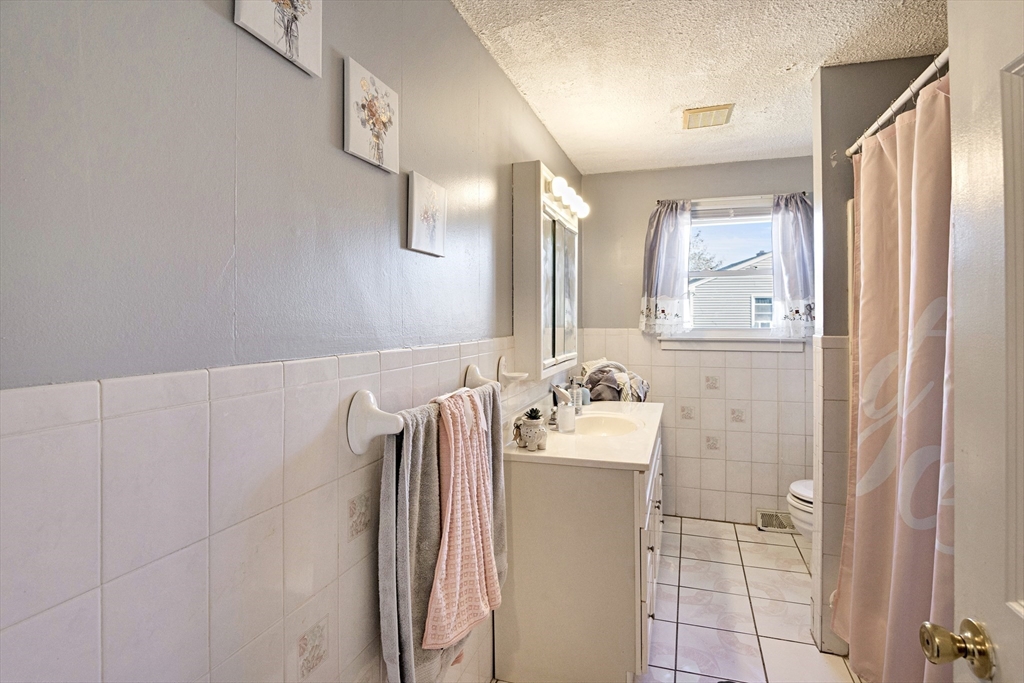 485 Riverside Road Springfield, MA 01107 - Photo 18 of 33 a bathroom with a sink a toilet and shower
