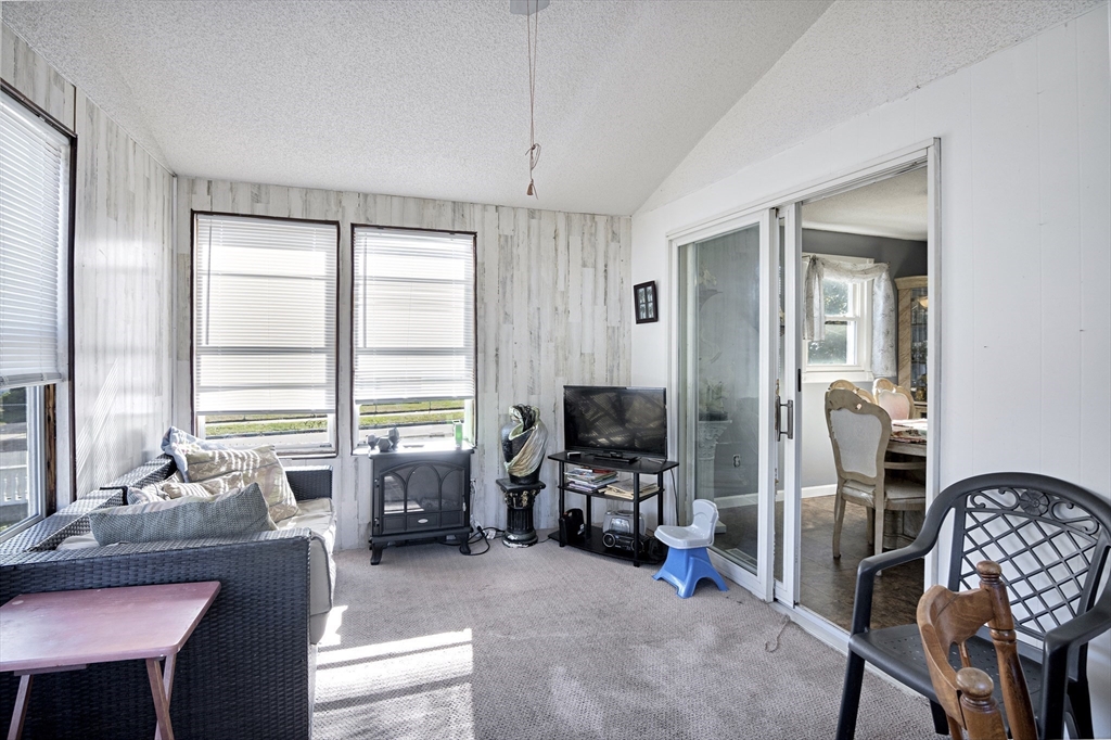 485 Riverside Road Springfield, MA 01107 - Photo 21 of 33 a living room with furniture a flat screen tv and a window