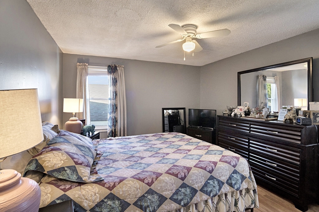 485 Riverside Road Springfield, MA 01107 - Photo 22 of 33 a bedroom with a bed and wooden floor