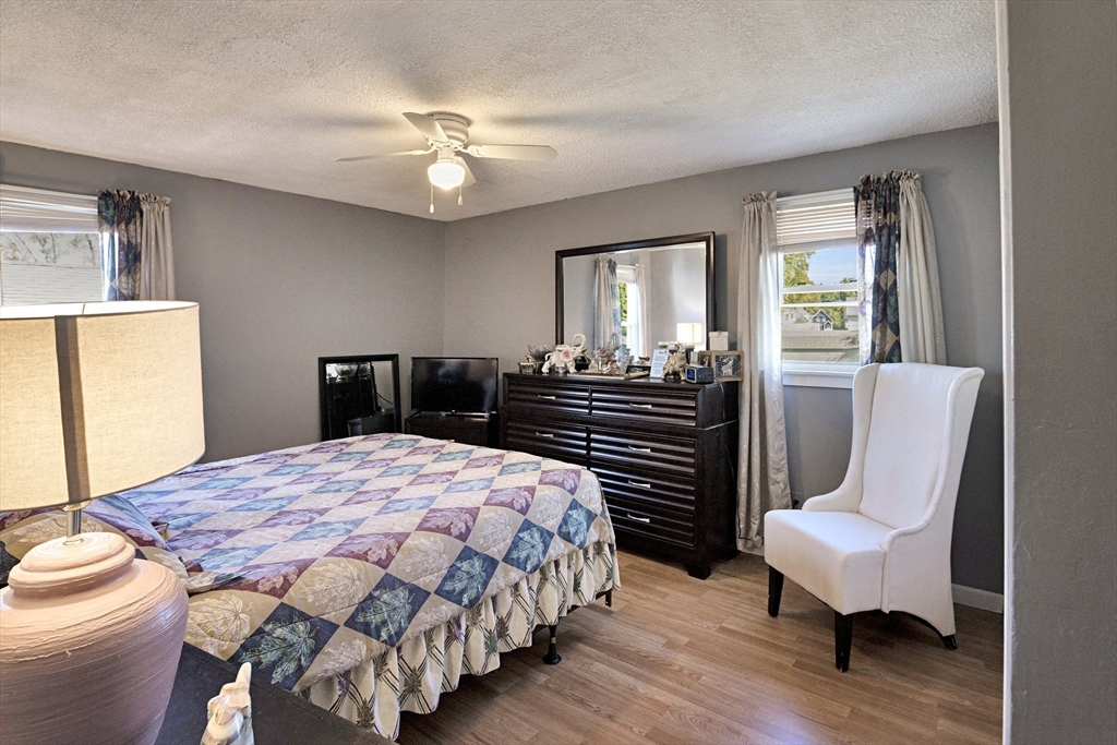 485 Riverside Road Springfield, MA 01107 - Photo 23 of 33 a bedroom with a bed and wooden floor