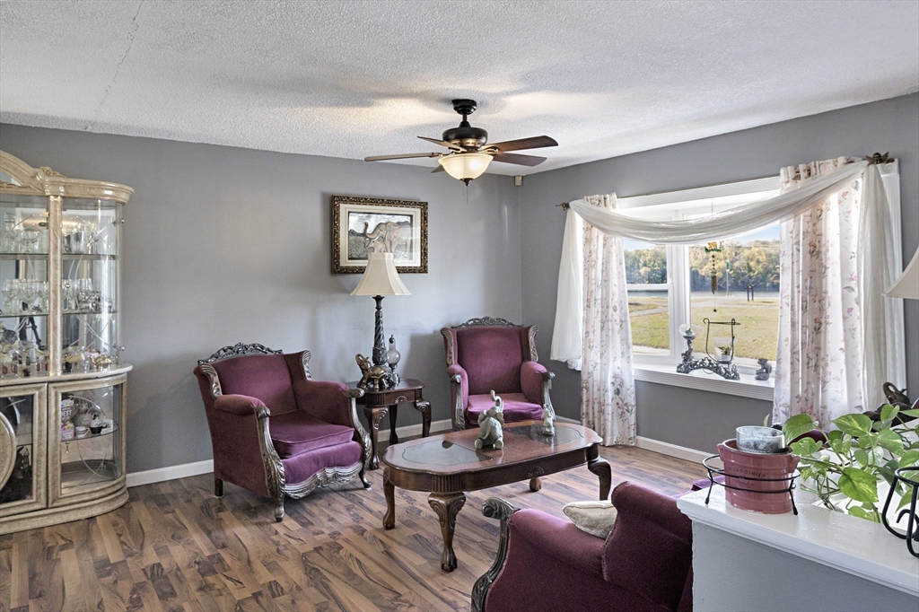485 Riverside Road Springfield, MA 01107 - Photo 9 of 33 a living room with furniture a chandelier and a window