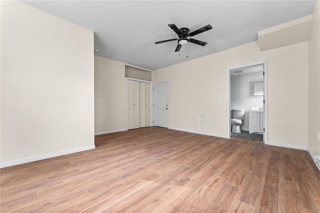 427 Adams Street Rochester, PA 15074 - Photo 8 of 25 a view of a livingroom with a hardwood floor and a ceiling fan