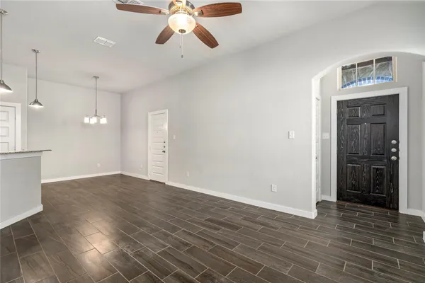 a kitchen with granite countertop a sink stove and refrigerator