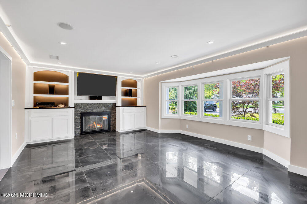 590 Lloyd Road Aberdeen, NJ 07747 - Photo 11 of 71 a living room with furniture and a flat screen tv