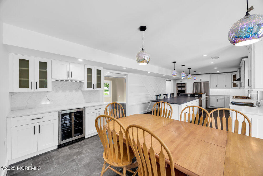 590 Lloyd Road Aberdeen, NJ 07747 - Photo 44 of 71 a kitchen with stainless steel appliances granite countertop a kitchen island a stove a table and chairs